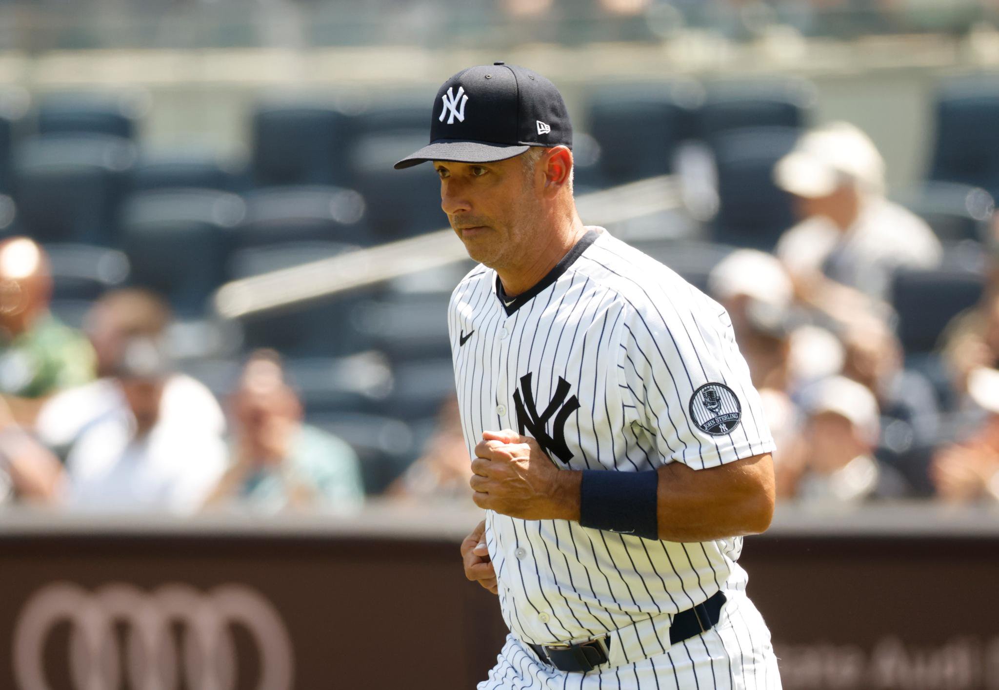 New York Yankees' Jorge Posada runs onto the field before Old Timers Day at Yankee Stadium.