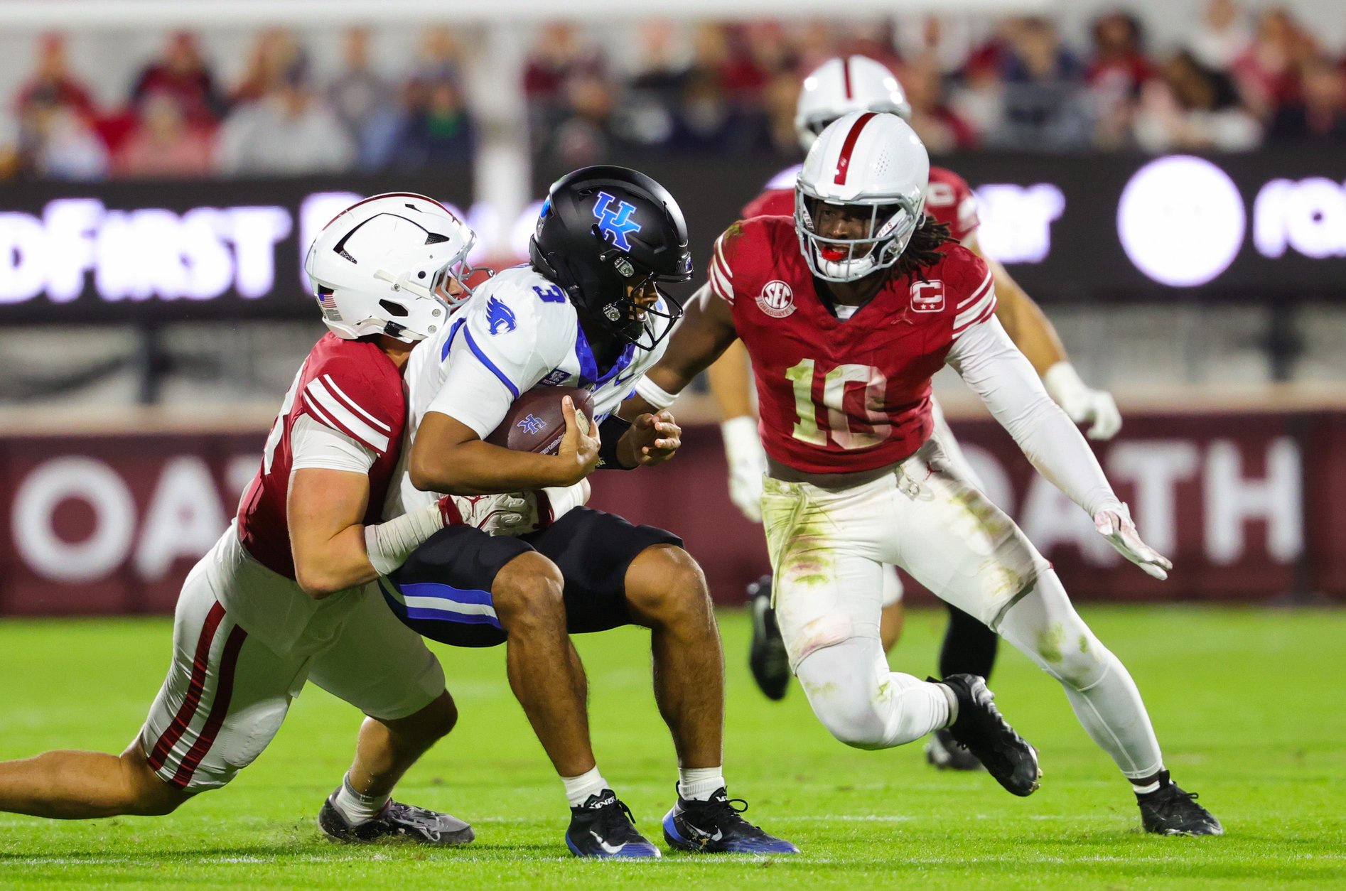 Oct 17, 2026; Norman, Oklahoma, USA; Oklahoma Sooners defensive lineman Jake Kreul (98) and Oklahoma Sooners linebacker Kip Lewis (10) tackle Kentucky Wildcats quarterback Kenny Minchey (3) during the first quarter at Gaylord Family-Oklahoma Memorial Stadium. Mandatory Credit: Kevin Jairaj-Imagn Images
