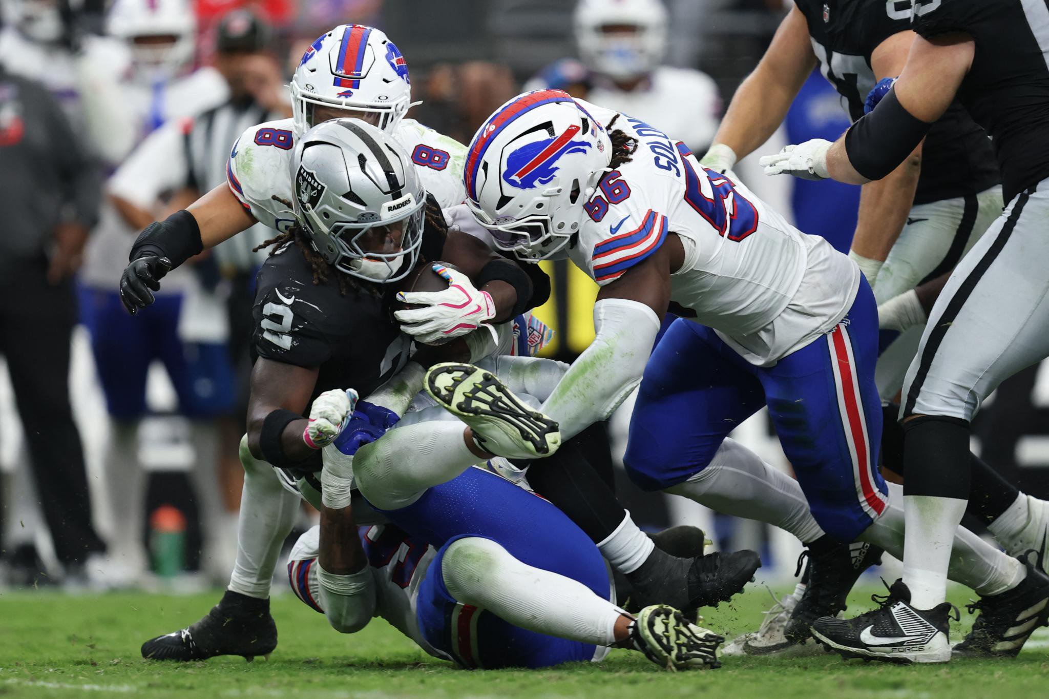 Las Vegas Raiders running back Ashton Jeanty is tackled by Buffalo Bills linebacker TJ Parker during a game.