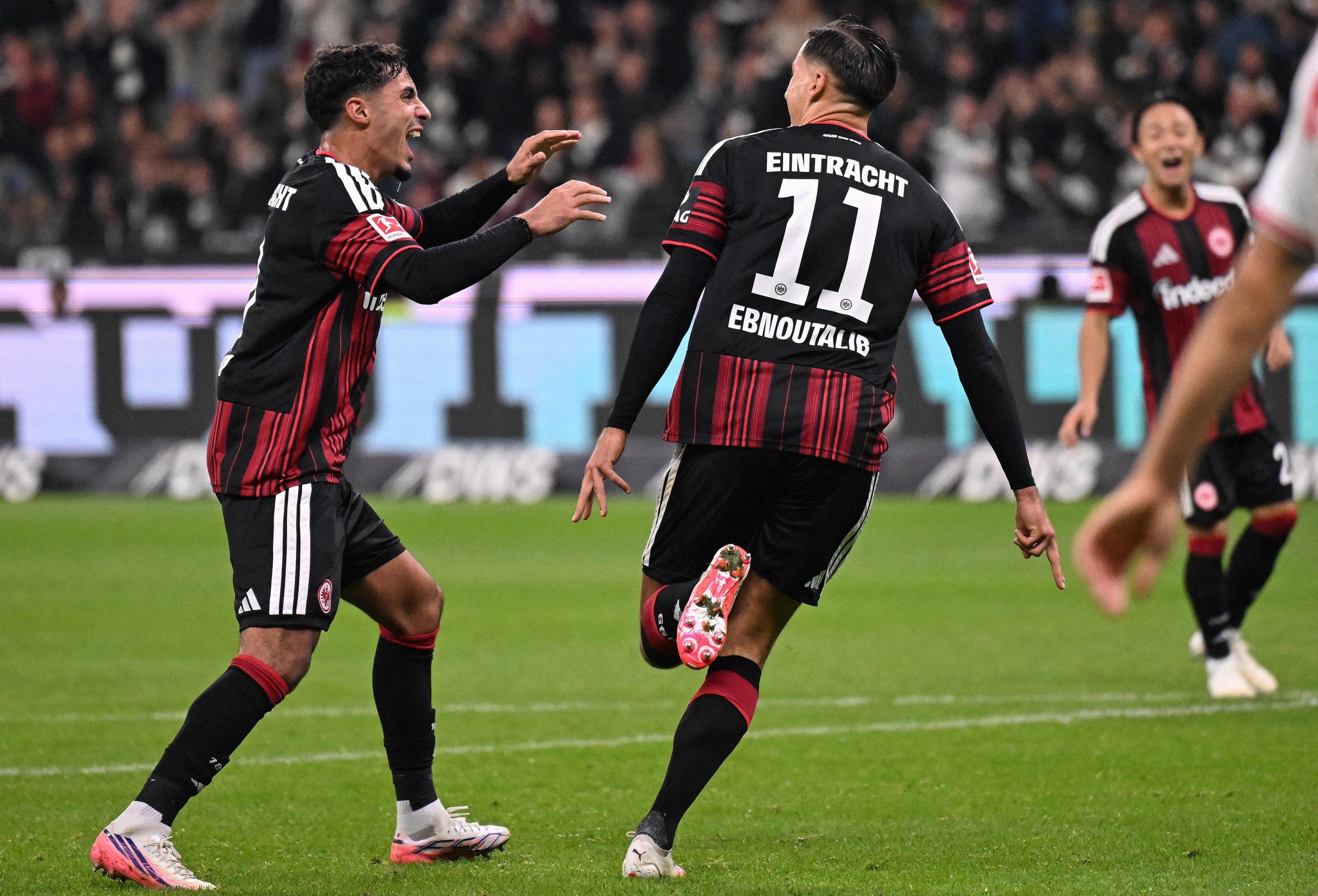 Frankfurt’s German forward #11 Younes Ebnoutalib (C) celebrates scoring the opening goal with his teammate Frankfurt’s Algerian midfielder #08 Fares Chaibi (L) during the German first division Bundesliga football match between Eintracht Frankfurt and FC Cologne in Frankfurt am Main, western Germany, on October 16, 2026. (Photo by Kirill KUDRYAVTSEV / AFP via Getty Images) / DFL REGULATIONS PROHIBIT ANY USE OF PHOTOGRAPHS AS IMAGE SEQUENCES AND/OR QUASI-VIDEO