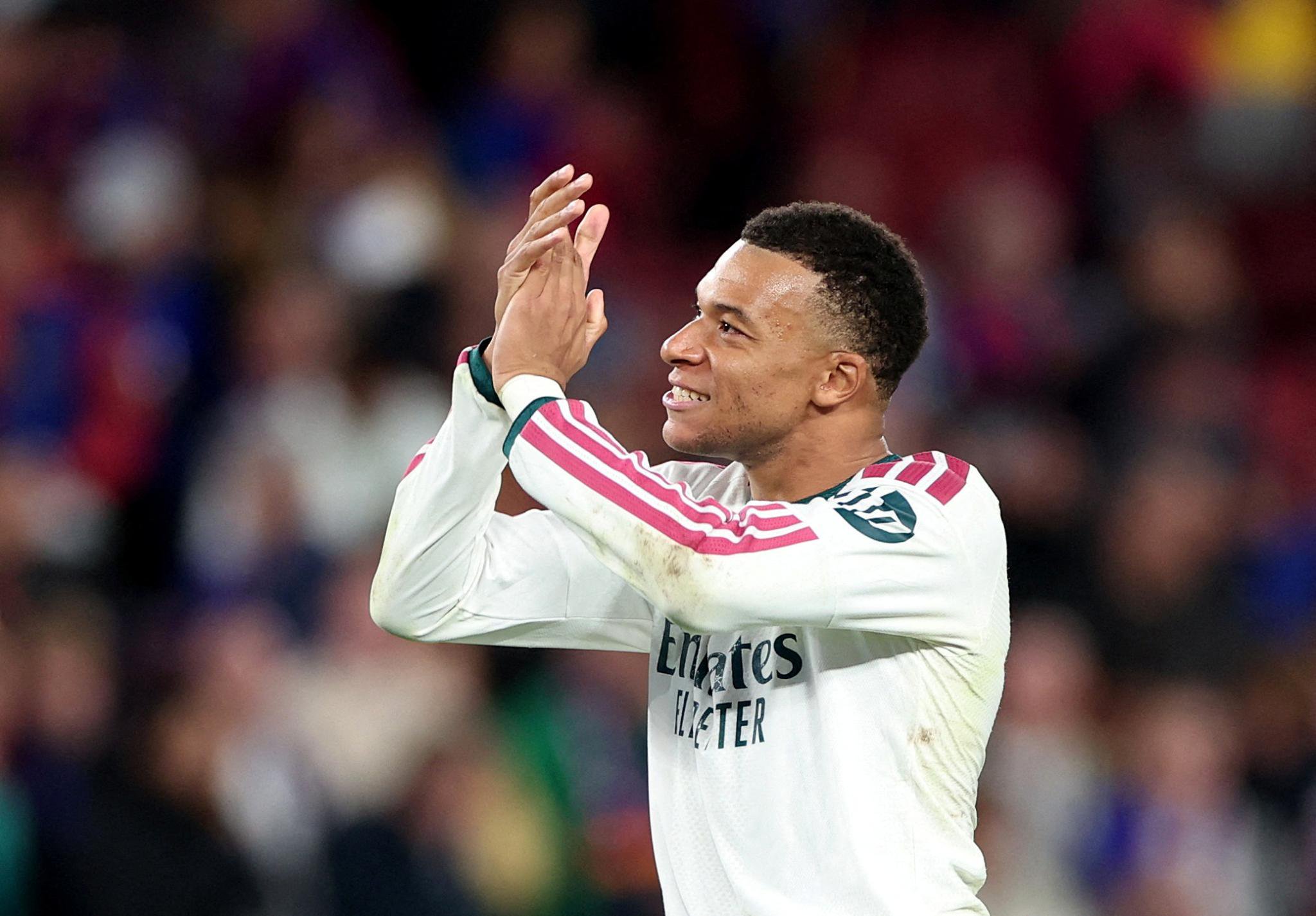 Real Madrid's Kylian Mbappe applauds fans after a match against FC Barcelona.