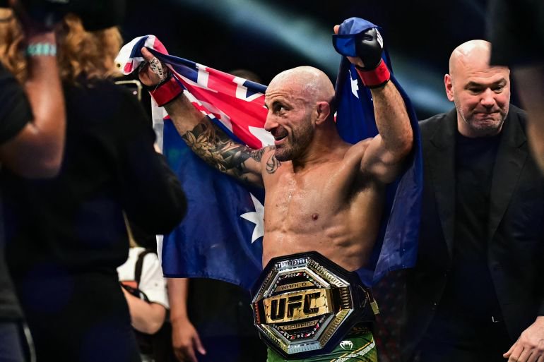 Australia's Alexander Volkanovski (C) celebrates after defeating Russia's Movsar Evloev in their men's featherweight fight during the UFC Fight Night event at Etihad Arena in Abu Dhabi early on October 25, 2026.