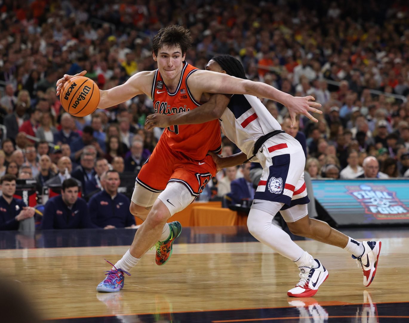 UConn guard Silas Demary Jr. fouls Illinois forward David Mirković during the second half of a Final Four semifinal April 4, 2026, at Lucas Oil Stadium in Indianapolis. (Armando L. Sanchez/Chicago Tribune)