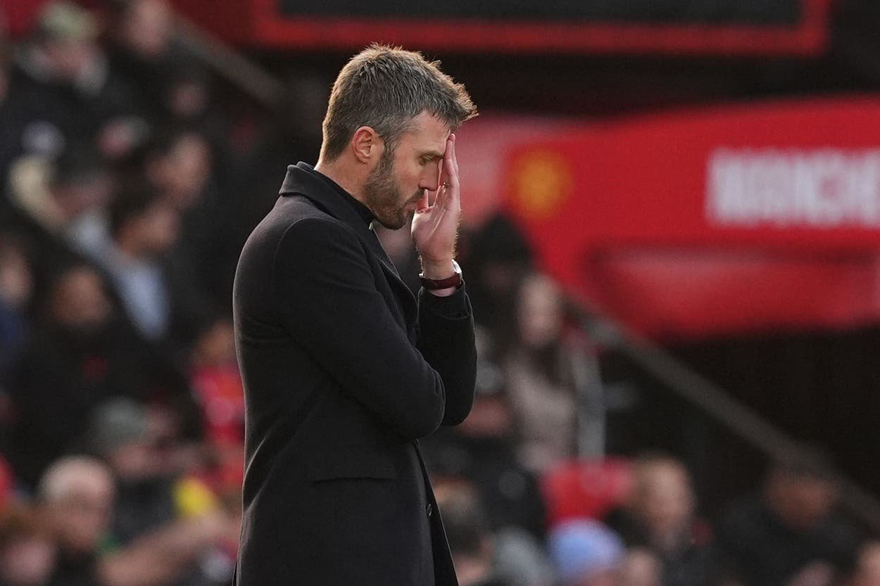 Michael Carrick appears dejected on the touchline (Martin Rickett/PA)