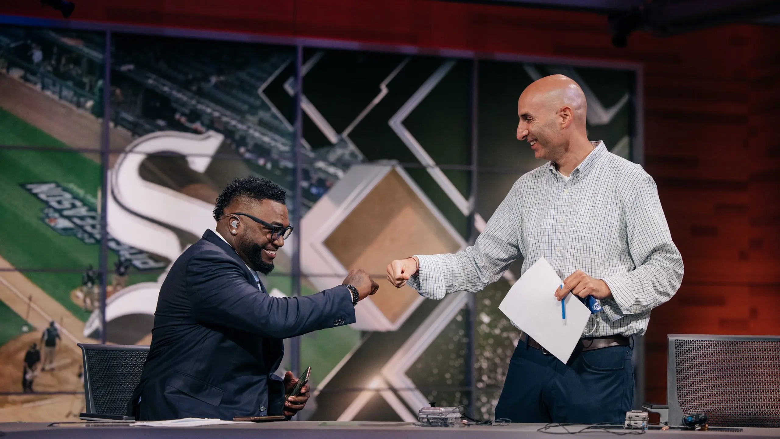 David Ortiz (left) and Fox coordinating producer Bardia Shah-Rais fist bump before a show.