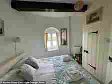 The main bedroom in the mill which has a double bed, a wardrobe and a small window
