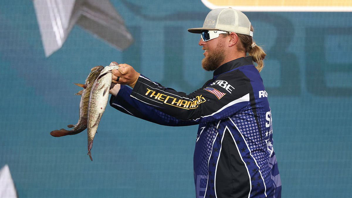 Matt Robertson holds up his fish after his weigh-in in Nashville.