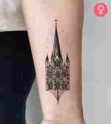 A minimalist cathedral tattoo on the forearm
