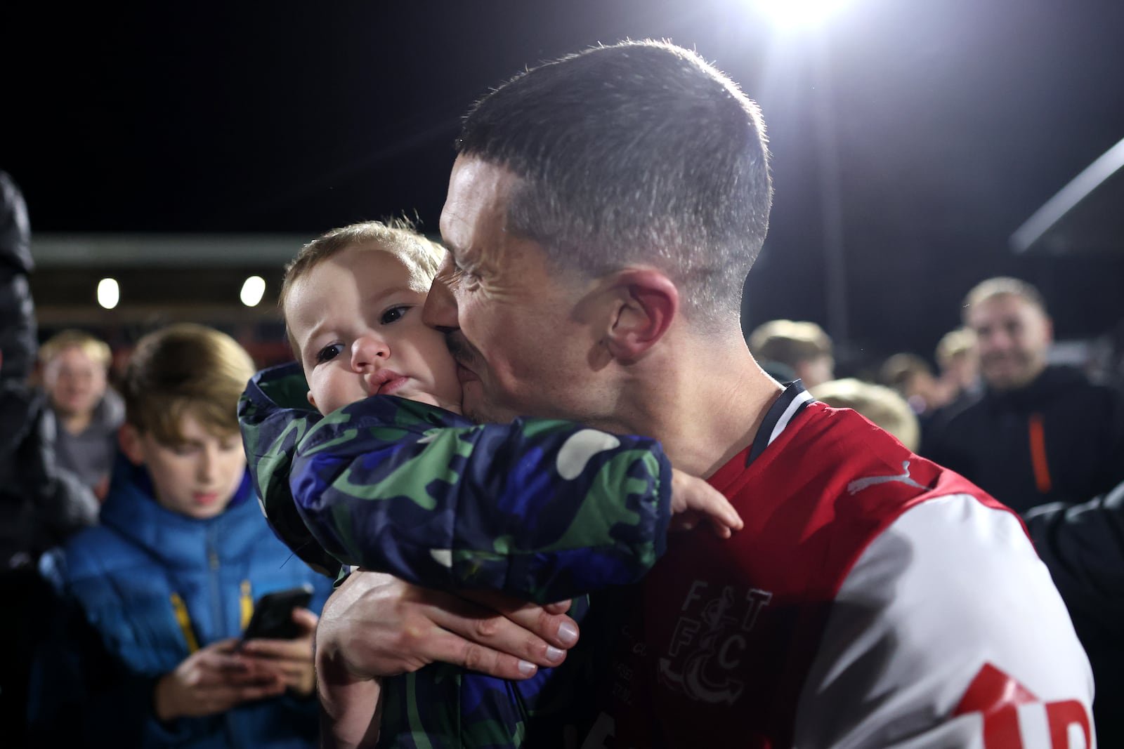 Fleetwood's Ronan Coughlan, from Limerick, celebrates with his baby after his side's win over Arsenal at Highbury Stadium. Photograph: Carl Recine/Getty Images
