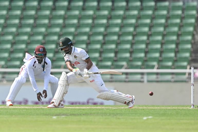 CORRECTION / Bangladesh's Shadman Islam (R) plays a shot as West Indies' wicketkeeper Amir Jangoo watches during the first day of the first test cricket match between Bangladesh and West Indies at the Sher-e-Bangla National Stadium in Mirpur on October 28, 2026.