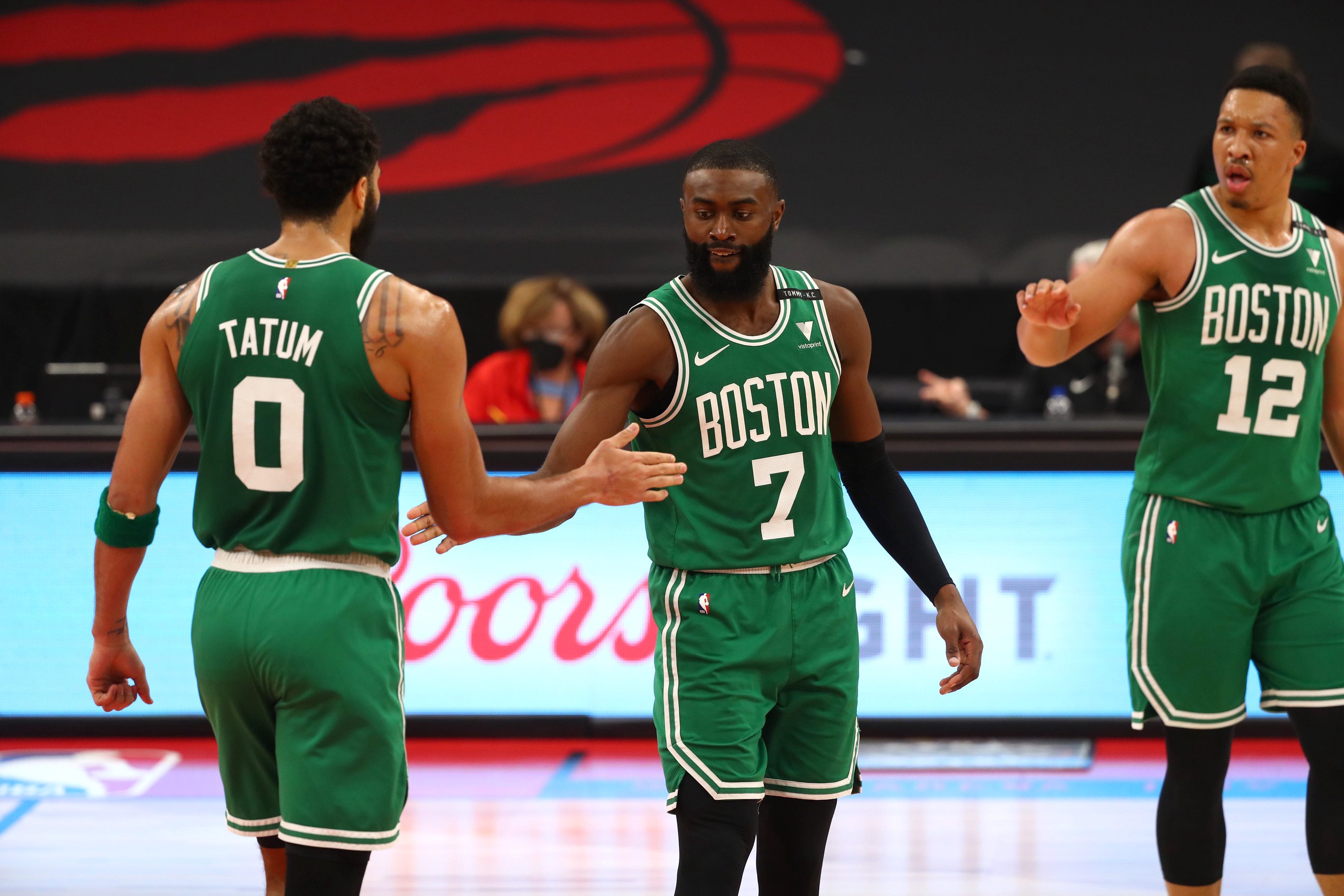 Jan 4, 2021; Tampa, Florida, USA; Boston Celtics forward Jayson Tatum (0) and guard Jaylen Brown (7) and forward Grant Williams (12) high five during the second quarter against the Toronto Raptors at Amalie Arena. Mandatory Credit: Kim Klement-USA TODAY Sports