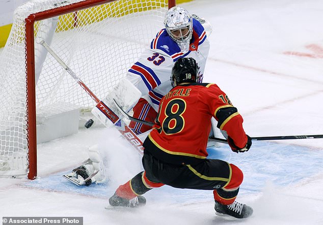 Ottawa Senators' Tim Stutzle (18) scores against New York Rangers goaltender Dylan Garand (33) during the first period of an NHL hockey game in Ottawa, Ontario, Saturday, Oct. 24, 2026. (Patrick Doyle/The Canadian Press via AP)