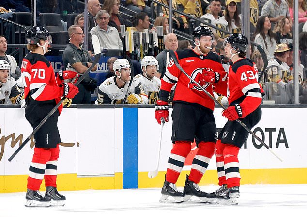 New Jersey Devils defenseman Luke Hughes (43) is congratulated by right wing Anthony Mantha (39) and center Jesper Boqvist (70) after scoring against the Vegas Golden Knights during the first period of an NHL hockey game Friday, Oct. 30, 2026, in Las Vegas. (Steve Marcus/Las Vegas Sun via AP)