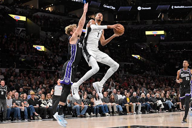 San Antonio Spurs center Victor Wembanyama (1) goes to the basket against Sacramento Kings center Domantas Sabonis during the first half of an NBA basketball game, Tuesday, Oct. 27, 2026, in San Antonio. (AP Photo/Darren Abate)