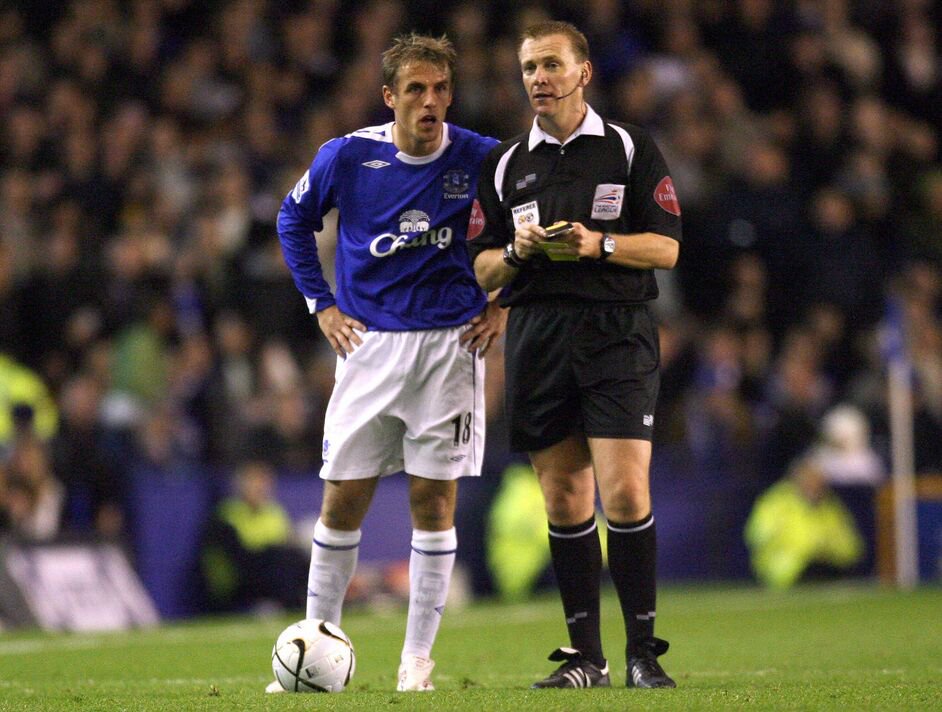 Everton captain Philip Neville speaks to referee