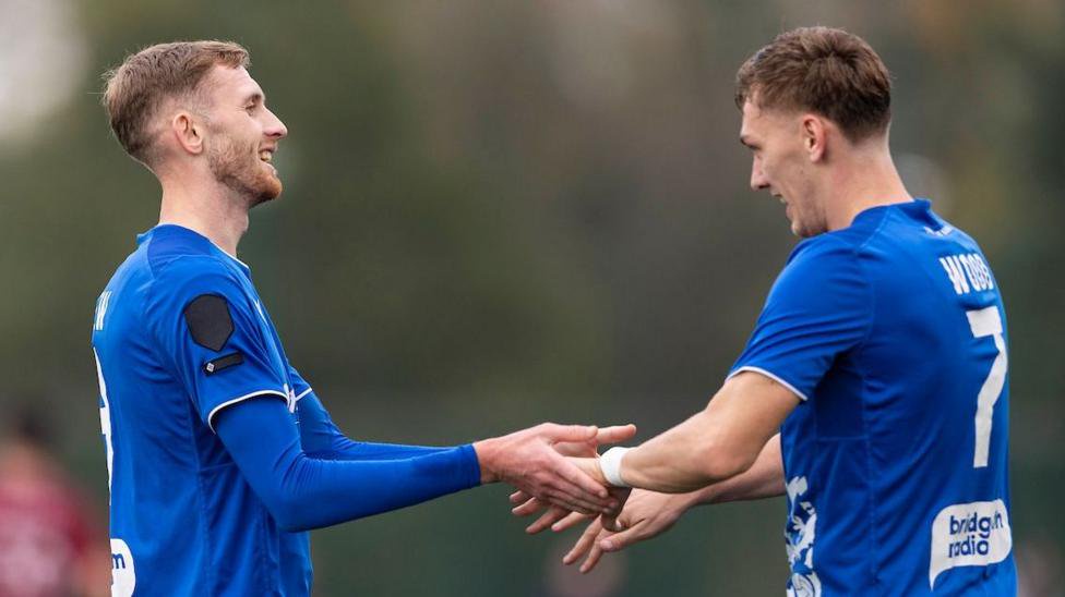Tom Mehew (left) celebrates with Penybont team-mate Nathan Wood (right)
