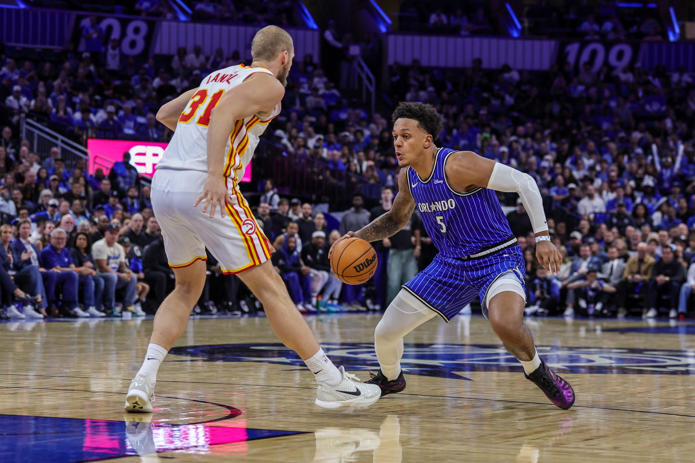 Oct 21, 2026; Orlando, Florida, USA;  Orlando Magic forward Paolo Banchero (5) dribbles against Atlanta Hawks center Jock Landale (31) during the second half at Kia Center.  Mandatory Credit: Mike Watters-Imagn Images
