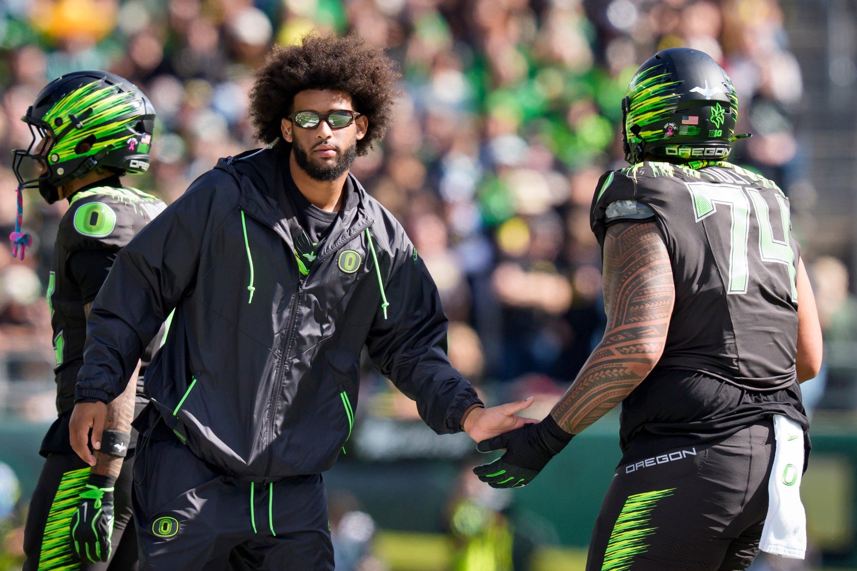 Oregon quarterback Dante Moore, left, greets Oregon offensive lineman Dave Iuli as the Oregon Ducks host the UCLA Bruins on Oct. 10, 2026, at Autzen Stadium in Eugene, Oregon.
