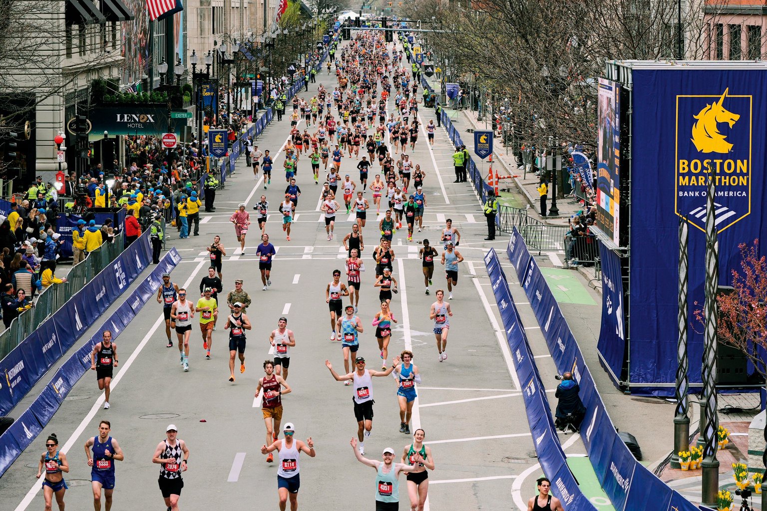 People run down a street for the marathon