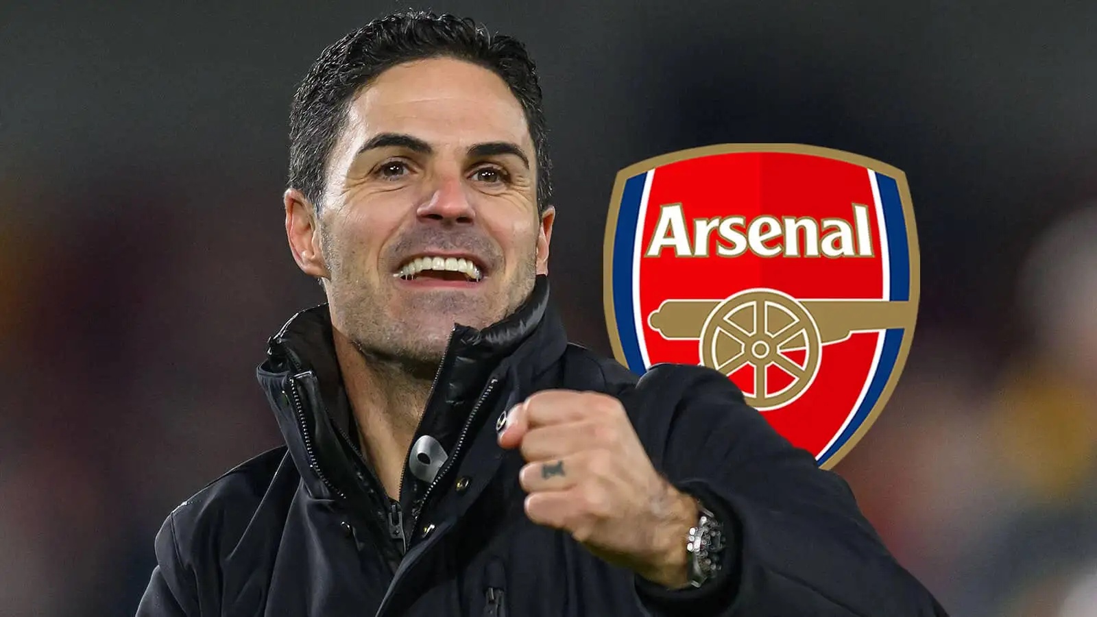 A happy Arsenal manager Mikel Arteta next to the club badge