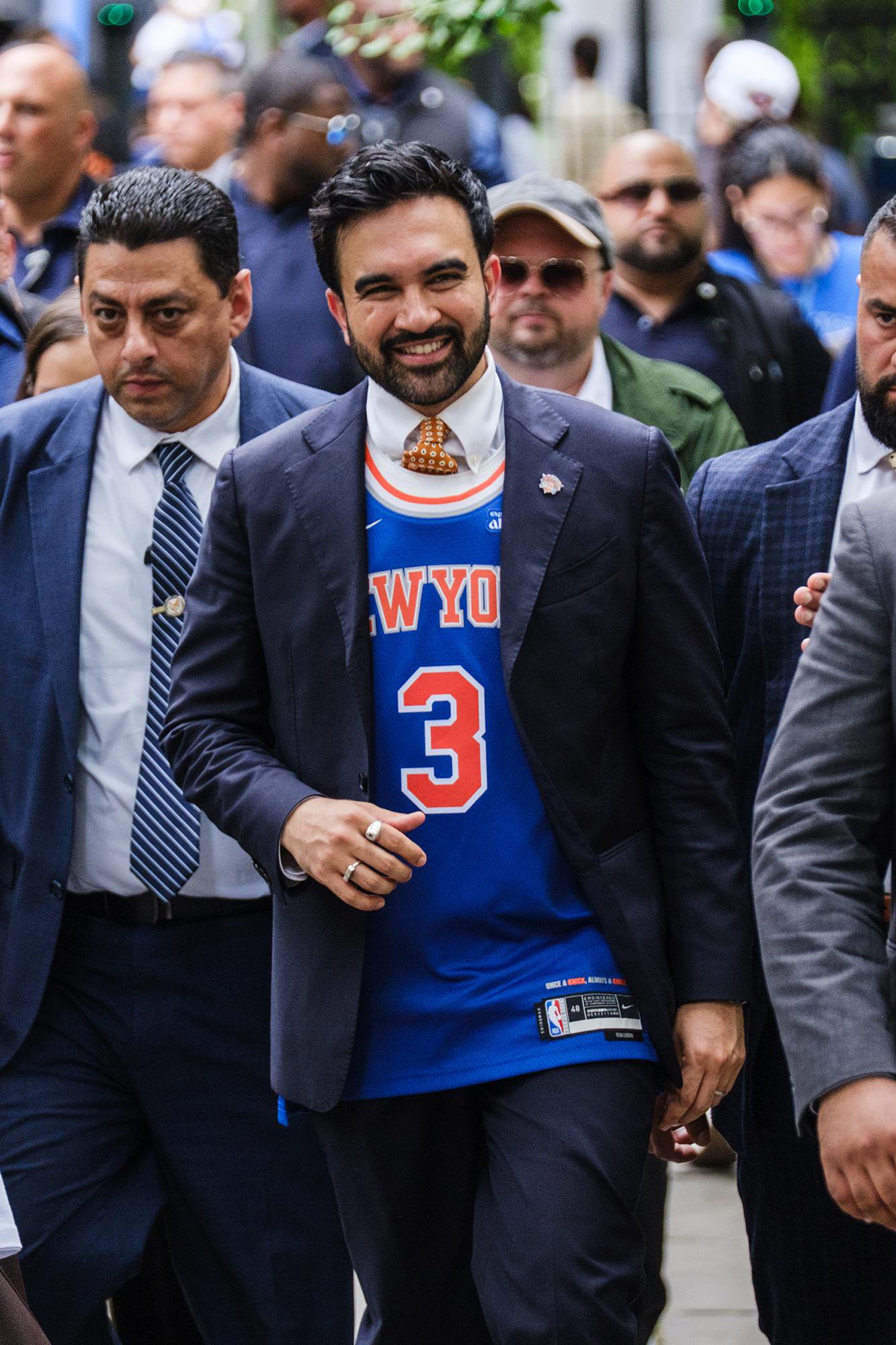 Zohran Mamdani arriving at City Hall in Manhattan wearing a New York Knicks jersey.