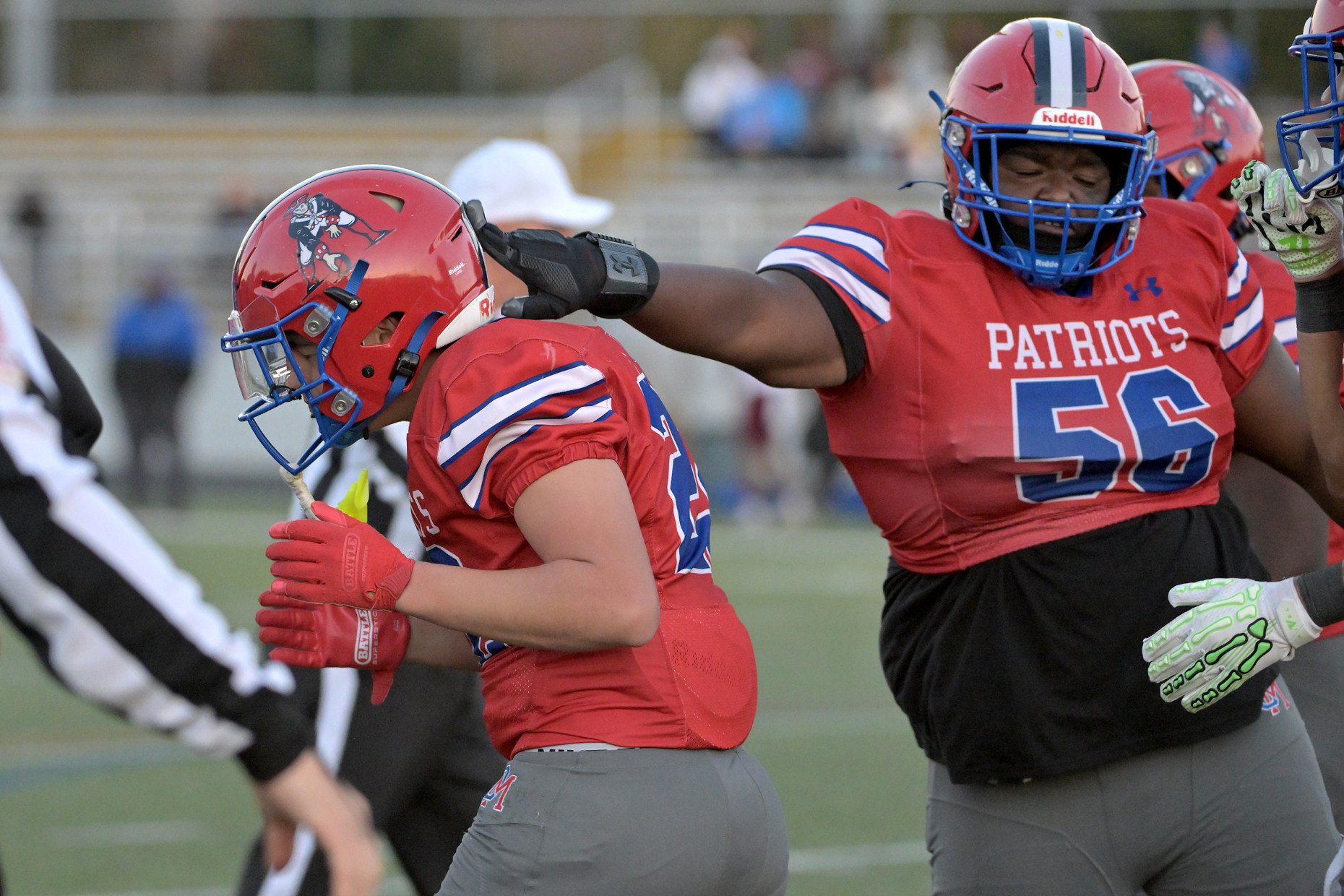 Old Mill Patriots Tyler McConville #22 is congratulated by teammate  Paul Douglas #56 after he runs for a touchdown in the first quarter. The Annapolis Panthers host the visiting Old Mill Patriots in a high school football held at Severna Park High School Friday evening. (Paul W. Gillespie/Staff)