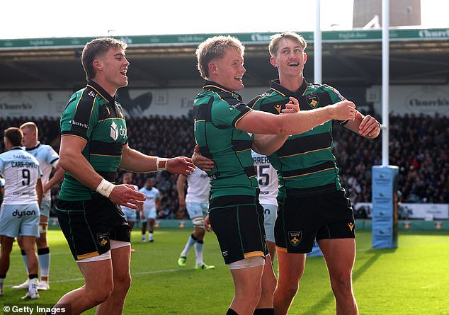 Pater celebrates a try with his Northampton team-mates Tommy Freeman (left) and Fin Smith