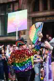 A man in sequin rainbow jacket at manchester pride