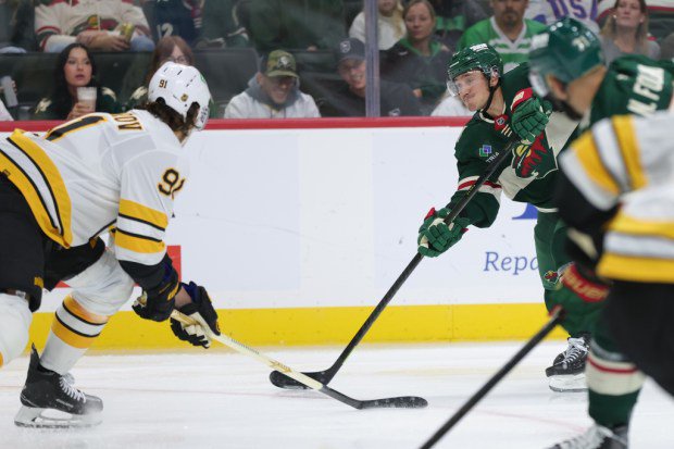 Minnesota Wild defenseman Jared Spurgeon , back right, shoots and scores during the third period of an NHL hockey game against the Boston Bruins, Saturday, Oct. 3, 2026, in St. Paul, Minn. (AP Photo/Bailey Hillesheim)