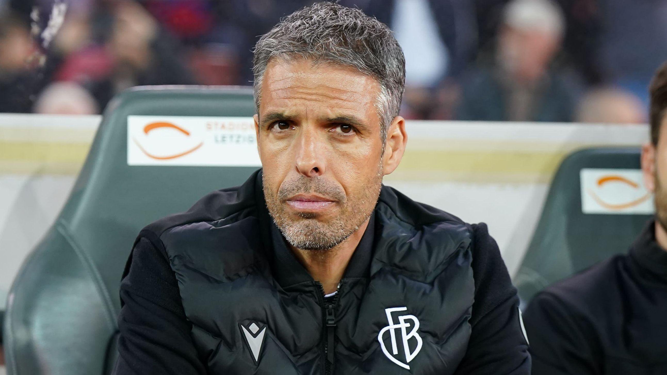 Fabio Celestini sat in the dugout wearing a black FC Basel jacket during a Swiss Super League match between FC Zurich and FC Basel at Stadion Letzigrund in April 2025