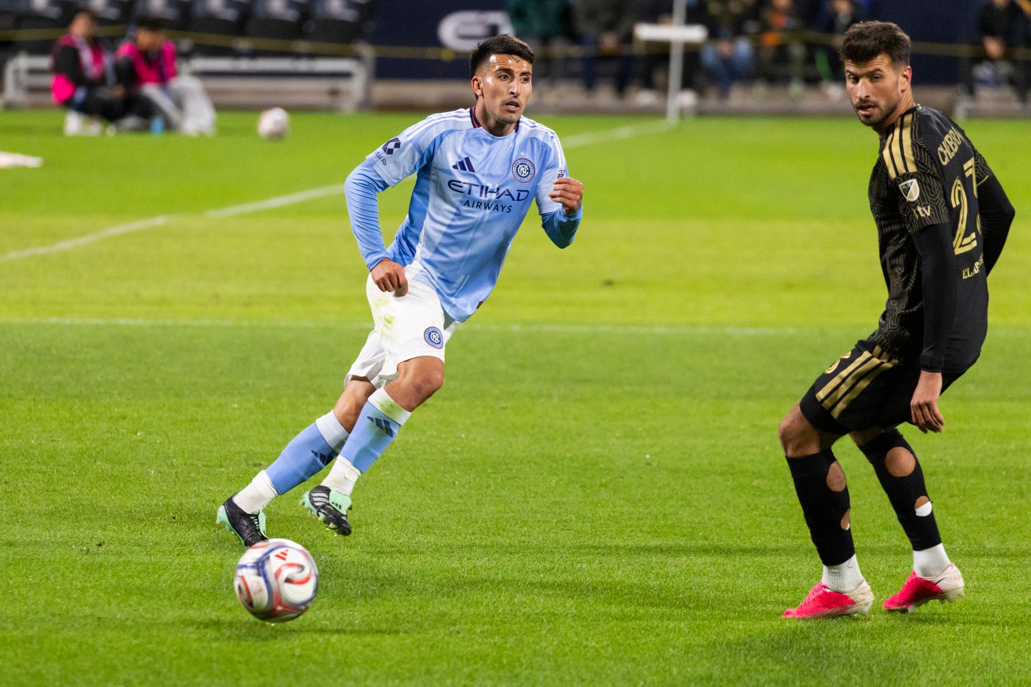 New York City midfielder Nicolás Fernández moves the ball down the pitch as Los Angeles FC defender Yevhen Cheberko defends during a match.
