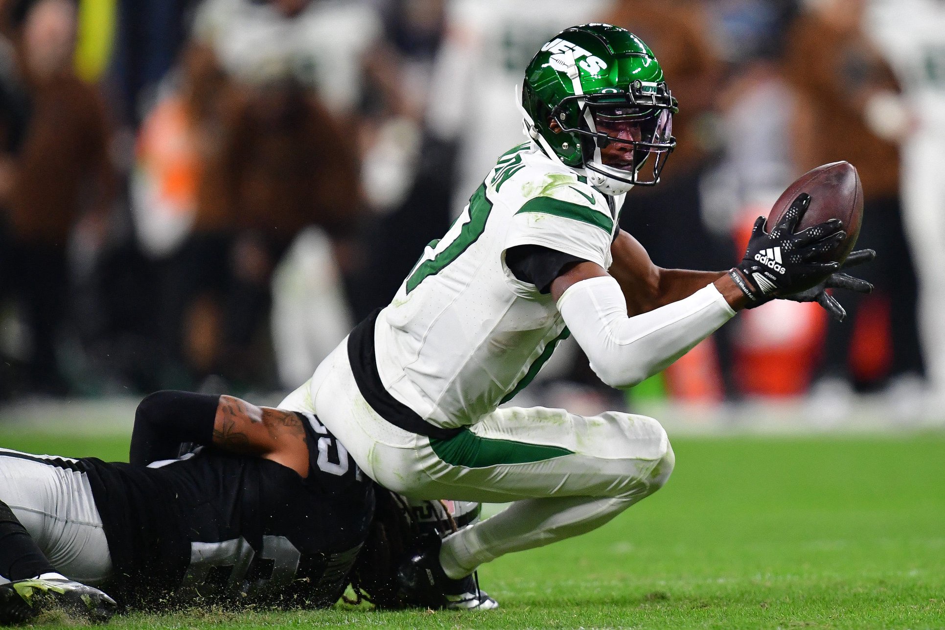 Nov 12, 2023; Paradise, Nevada, USA; New York Jets wide receiver Garrett Wilson (17) is brought down by Las Vegas Raiders safety Tre'von Moehrig (25) during the second half at Allegiant Stadium. Mandatory Credit: Gary A. Vasquez-USA TODAY Sports