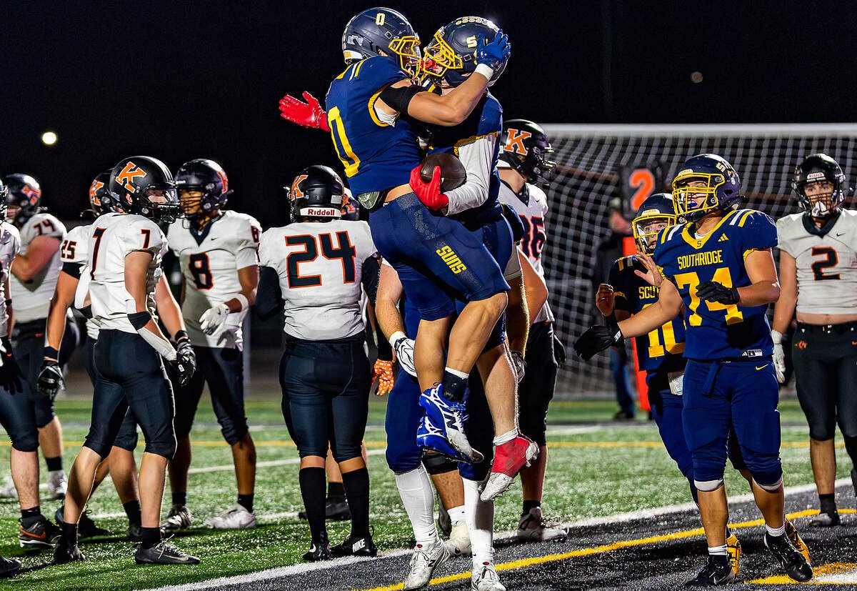 Southridge's Toa Haertling (0) celebrates with teammate Jacob Korotkov (7) following Korotkov's touchdown against Kennewick on Thursday, at Neil F. Lampson Stadium in Kennewick