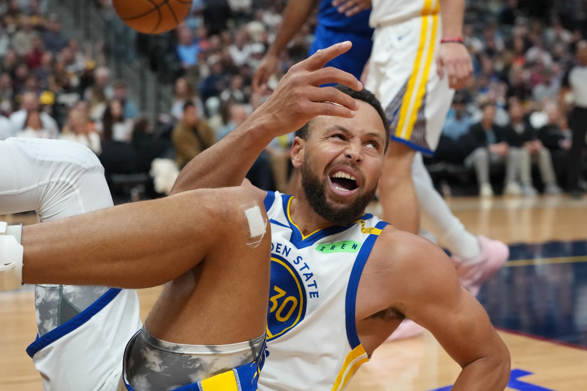 Golden State Warriors guard Stephen Curry reacts after being fouled while driving to the rim against the Denver Nuggets.