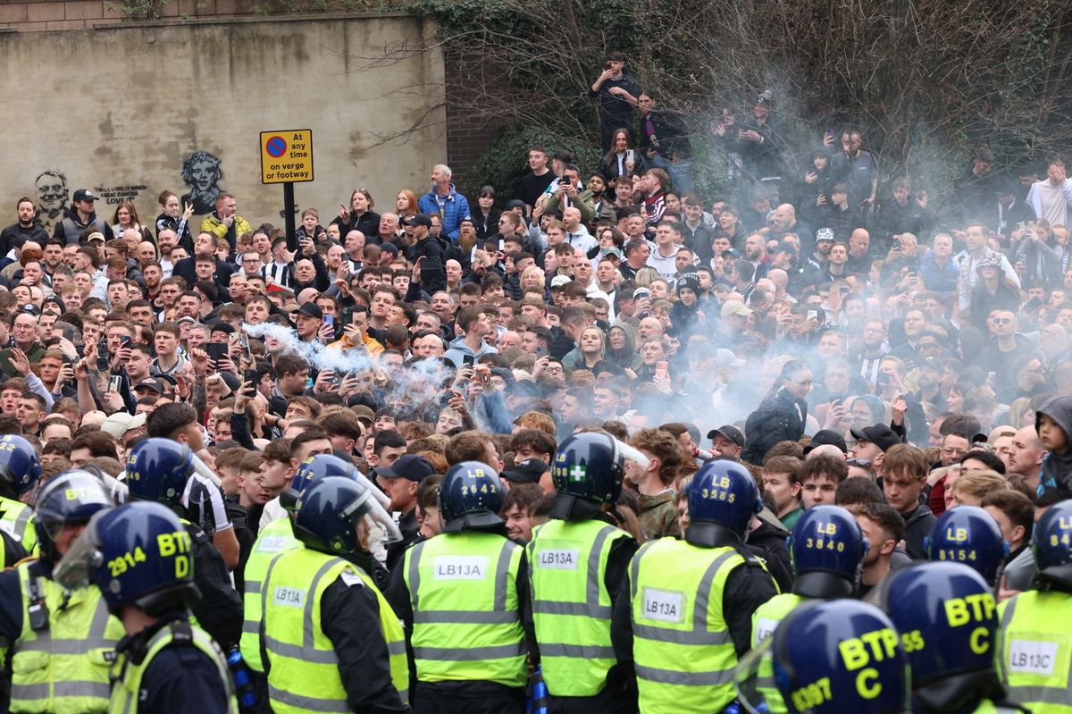 Police officers escort Sunderland AFC supporters from St James' Park to Newcastle Central Station after the Tyne and Wear Derby match against Newcastle United