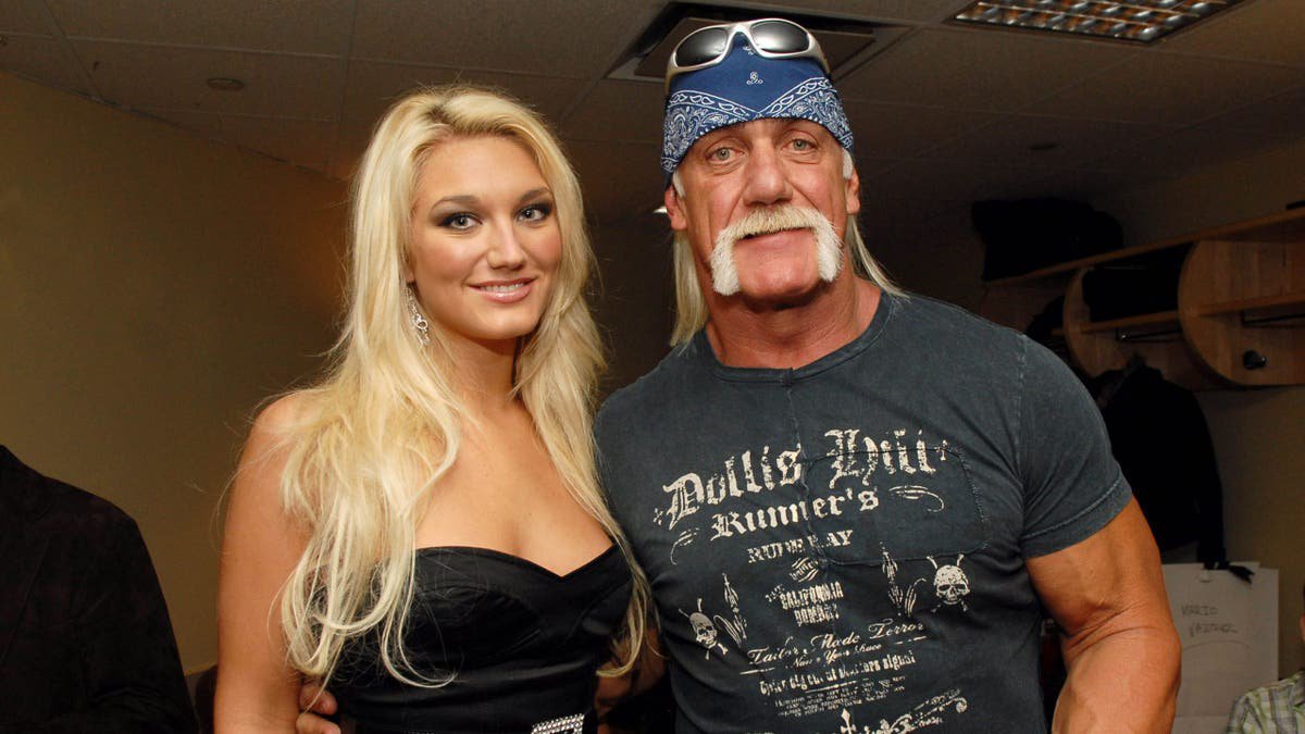 Brooke Hogan and Hulk Hogan pose together at an event.