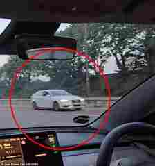 A Tesla driver is later heard beeping his horn to try and alert the driver, who seems unphased by the danger they are causing to other motorists