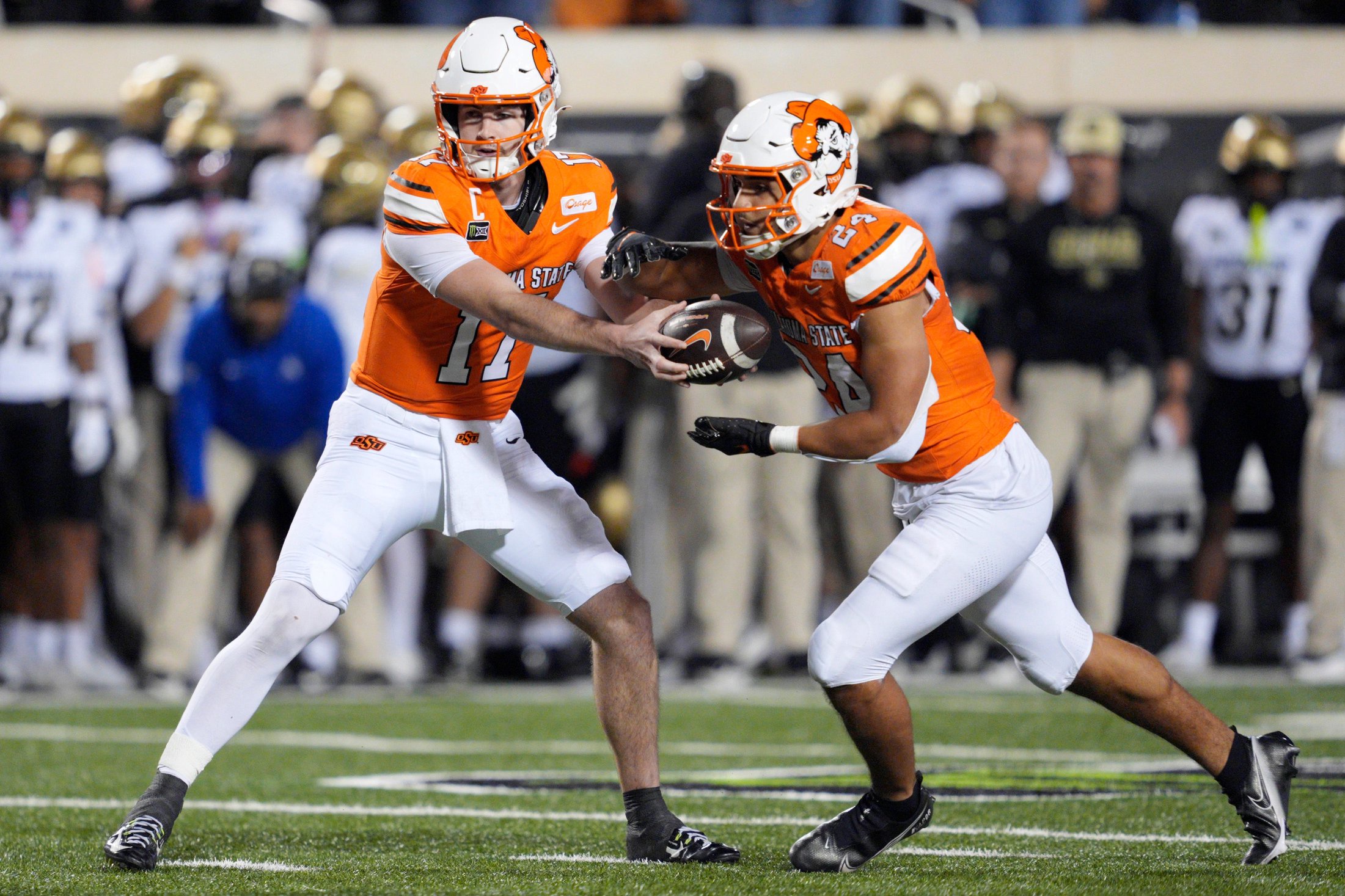 Oklahoma State Cowboys quarterback Drew Mestemaker (17)  hands off to running back Caleb Hawkins (24) during a college football game between the Oklahoma State Cowboys (OSU) and the Colorado Buffaloes at Boone Pickens Stadium in Stillwater, Okla., Saturday, Oct. 24, 2026. Oklahoma State won 57-24.