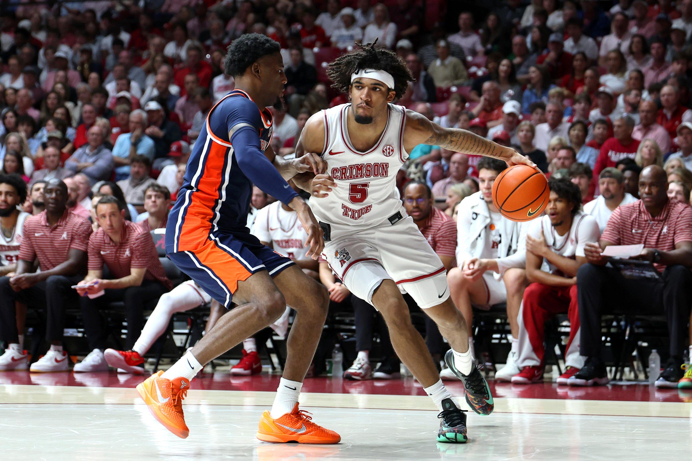 Mar 7, 2026; Tuscaloosa, Alabama, USA; Alabama Crimson Tide forward Amari Allen (5) dribbles against Auburn Tigers guard Kevin Overton (1) during the second half at Coleman Coliseum. Mandatory Credit: David Leong-Imagn Images