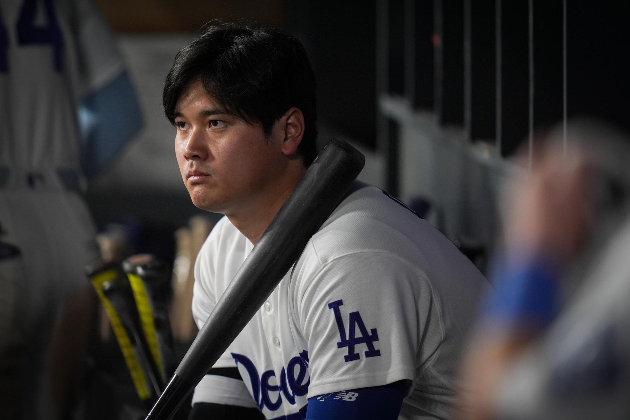 Los Angeles Dodgers designated hitter Shohei Ohtani watches from the dugout during Game 4 of baseball's National League Championship Series.