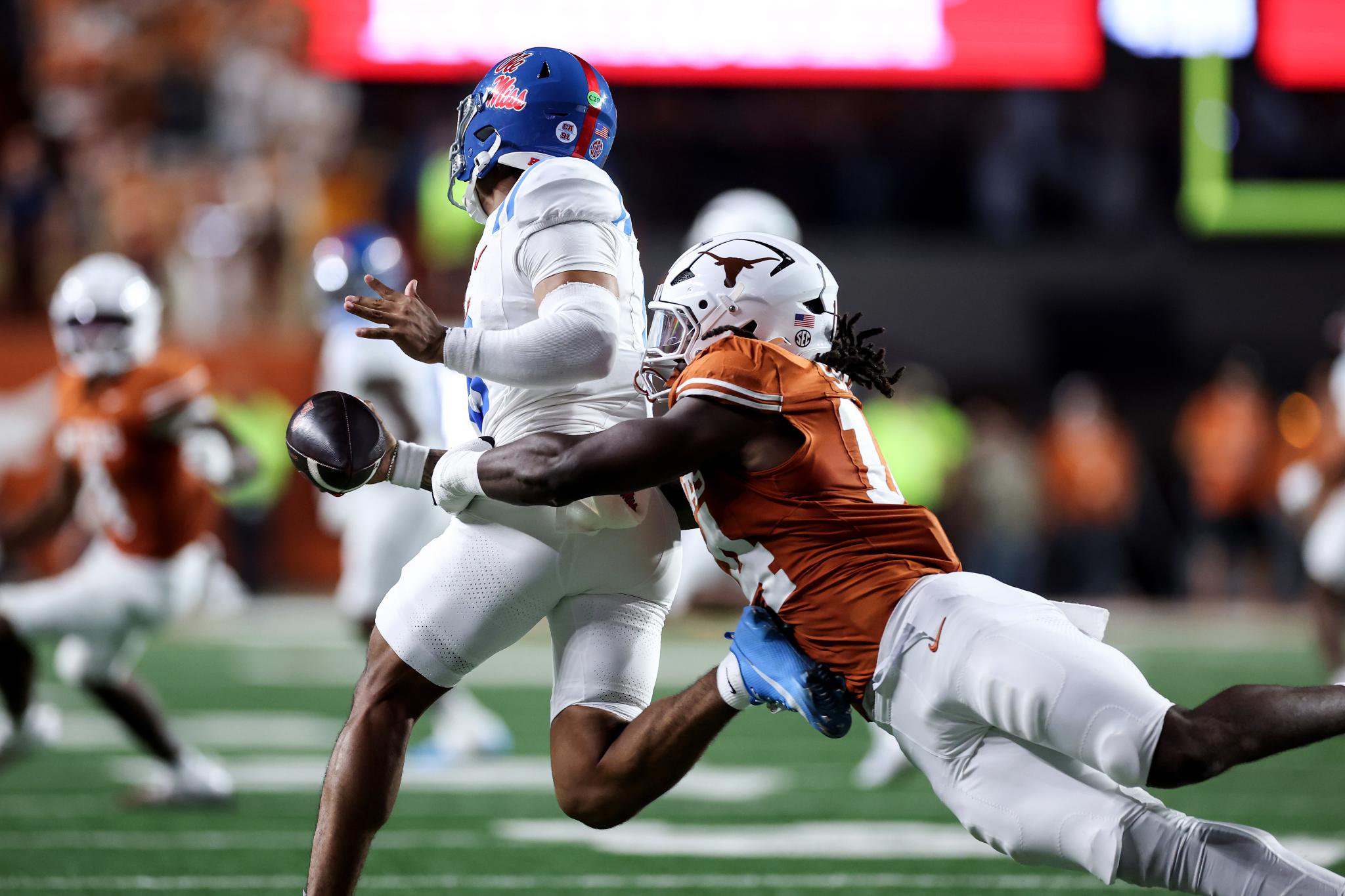 Texas Longhorns' Brad Spence (14) tackles Ole Miss Rebels' Trinidad Chambliss (6).