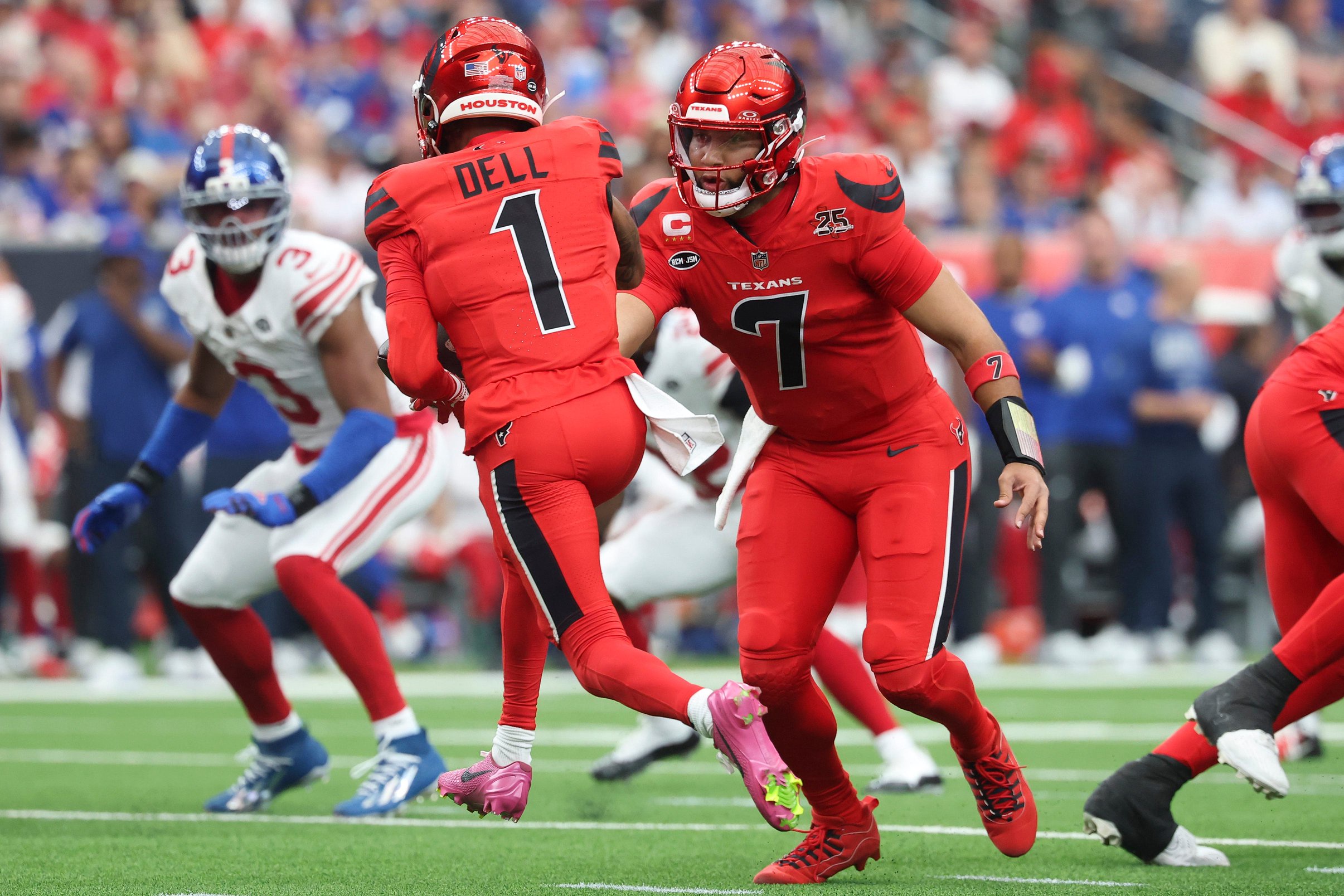 Oct 25, 2026; Houston, Texas, USA;  Houston Texans quarterback C.J. Stroud (7) hands off to wide receiver Tank Dell (1) during the third quarter against the New York Giants at Reliant Stadium.  Mandatory Credit: Troy Taormina-Imagn Images