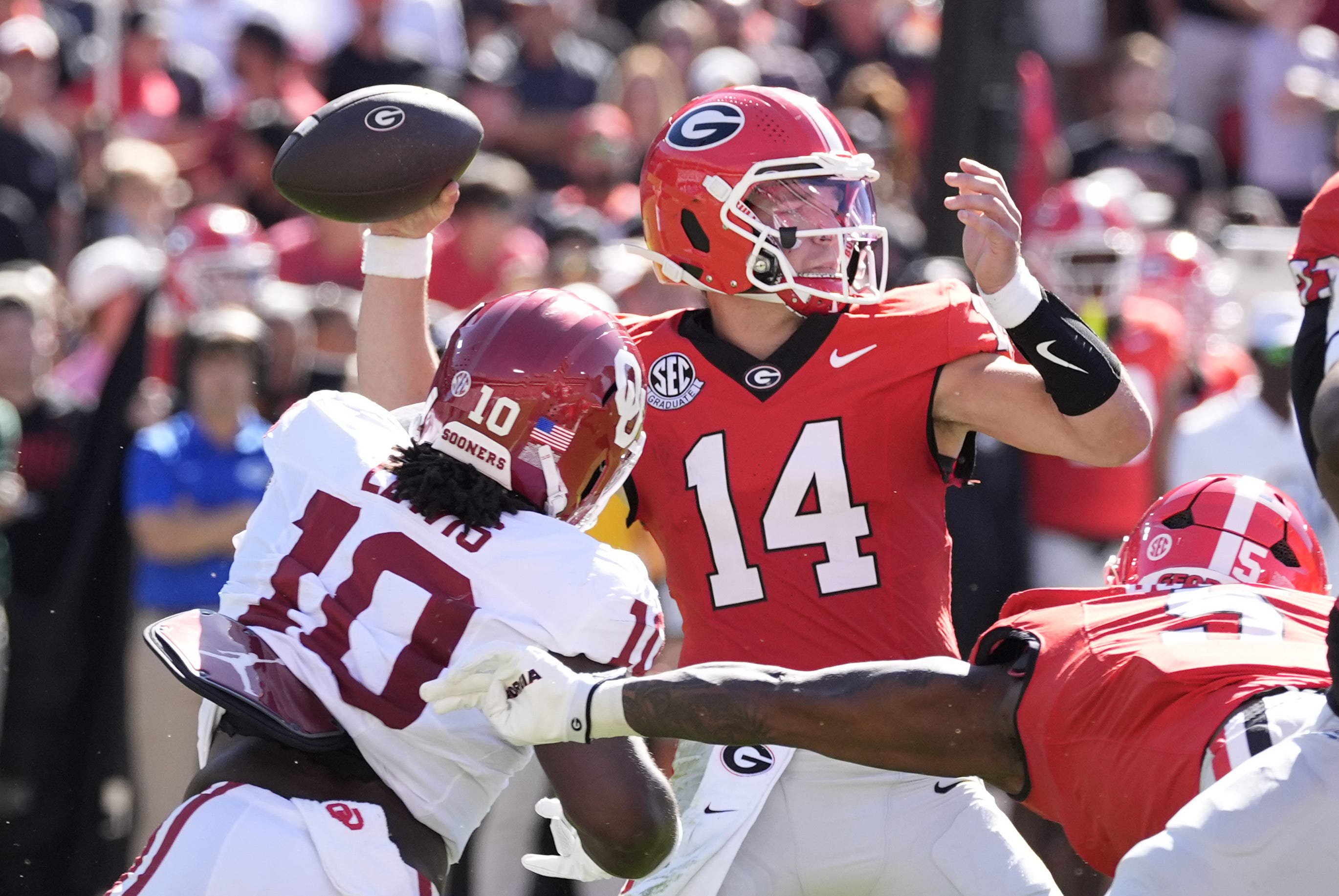 Sep 26, 2026; Athens, Georgia, USA;  Georgia Bulldogs quarterback Gunner Stockton (14) throws a pass against Oklahoma Sooners linebacker Kip Lewis (10)  during the first half at Sanford Stadium.  Mandatory Credit: Dale Zanine-Imagn Images