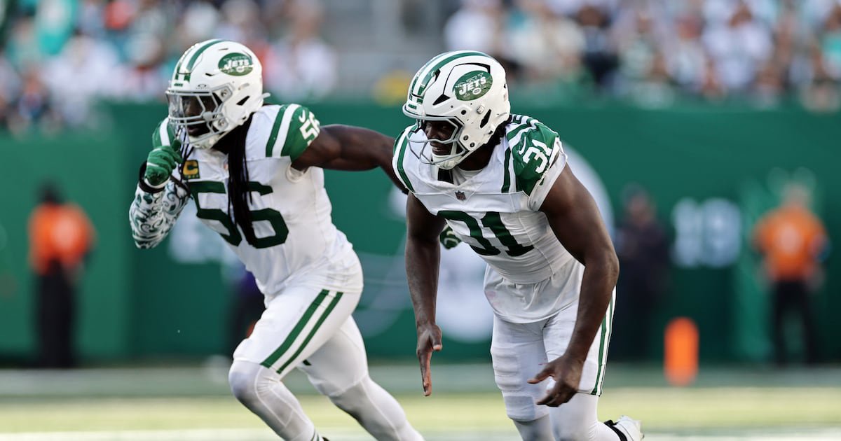 New York Jets linebacker David Bailey (31) and Demario Davis (56) defend during an NFL football game against the Miami