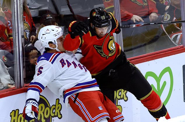 Ottawa Senators' Drake Batherson (19) collides with New York Rangers' Sean Durzi (5) during the first period of an NHL hockey game in Ottawa, Ontario, Saturday, Oct. 24, 2026. (Patrick Doyle/The Canadian Press via AP)