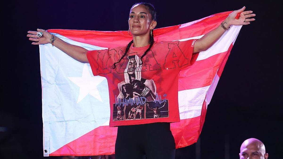 Amanda Serrano holds up the Puerto Rico flag