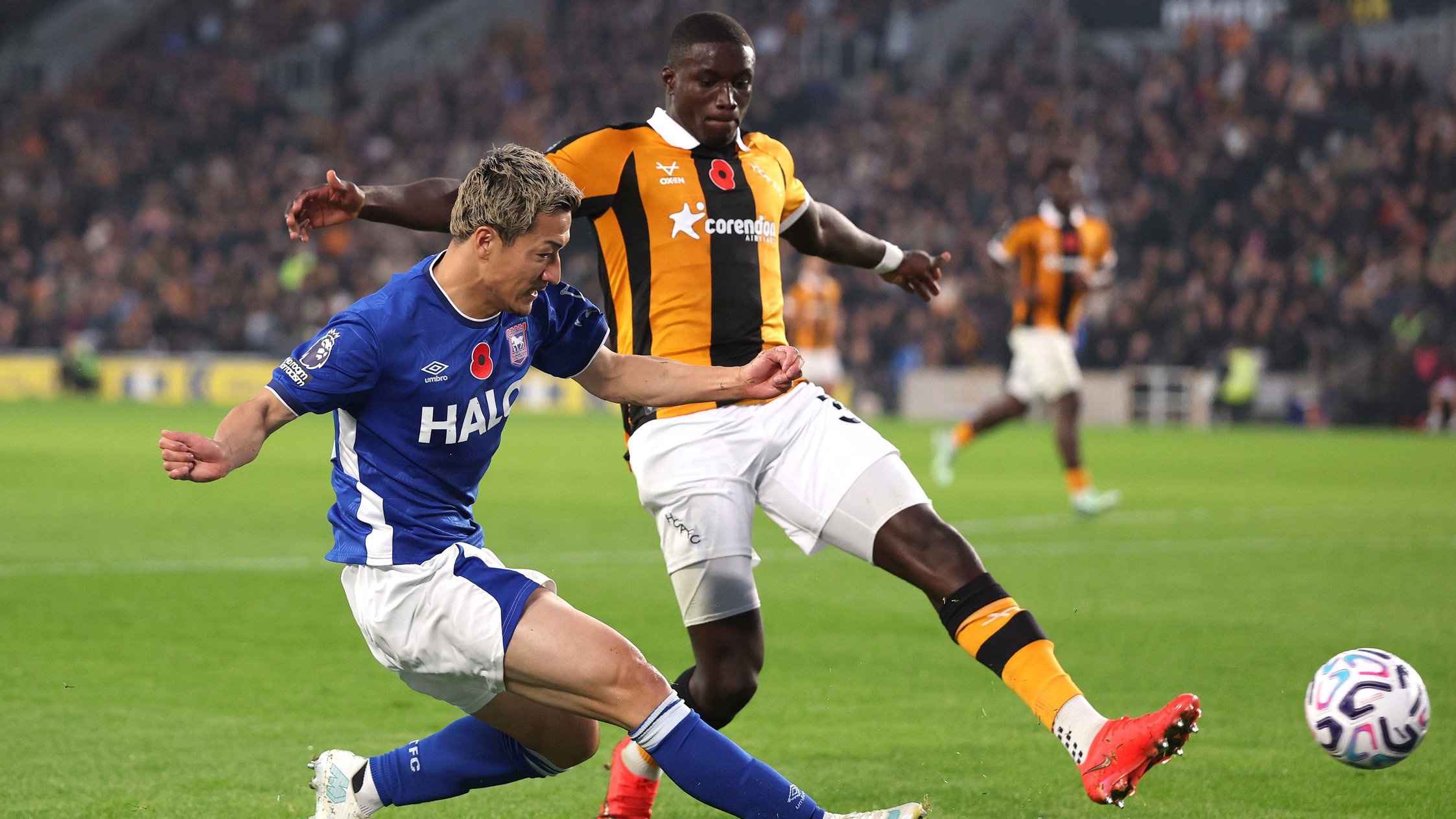 Daizen Maeda of Ipswich Town crosses the ball whilst under pressure from Nobel Mendy of Hull City during the Premier League 2026-27 match at MKM Stadium on October 31, 2026