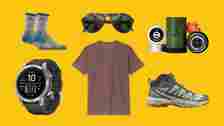 A collection of outdoor items, including a t-shirt, socks, watch, shoes and sunglasses on a yellow background