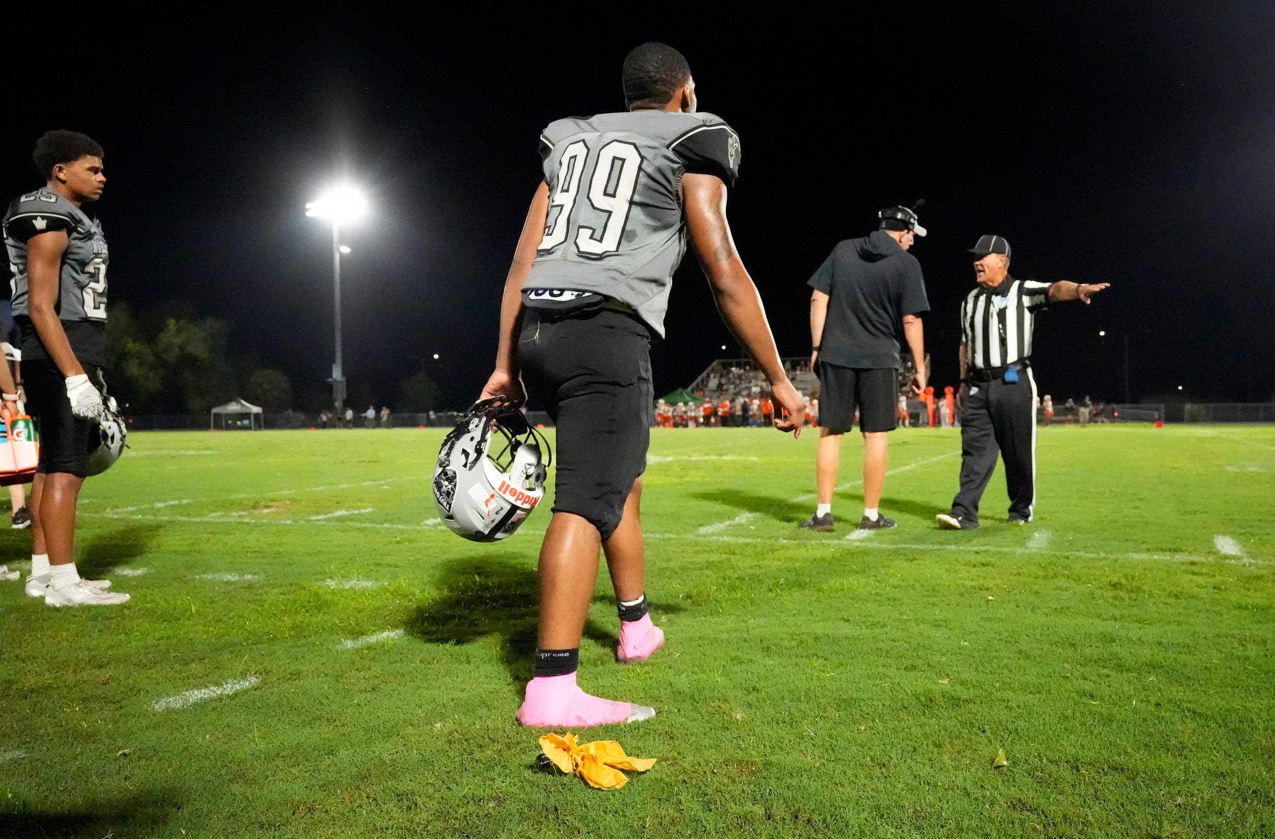 Sideline referee Ben Pfaff throws his penalty flag at the Mariner bench to warn them about excessive celebration after a touchdown. The Dunbar High School Tigers visited the Mariner High School Tritons Thursday, Oct. 8, 2026 for a 4A District 11 football matchup. 
Dunbar walked away with the victory with a final score of 60-20.