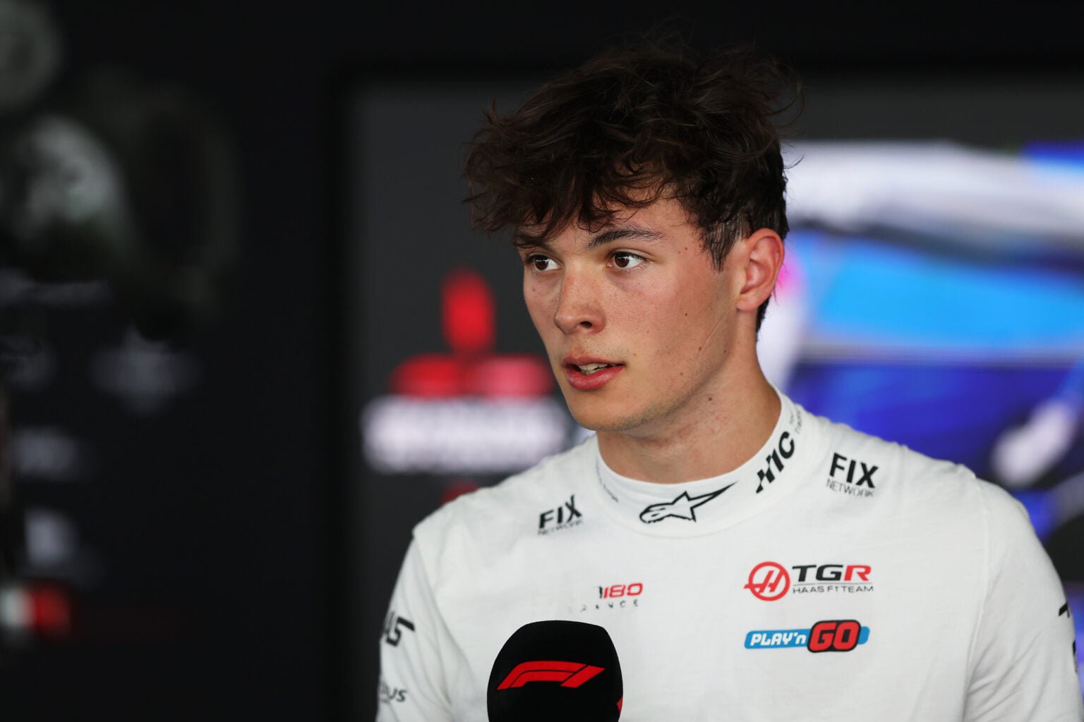 Oliver Bearman of Haas speaks in the F1 media pen